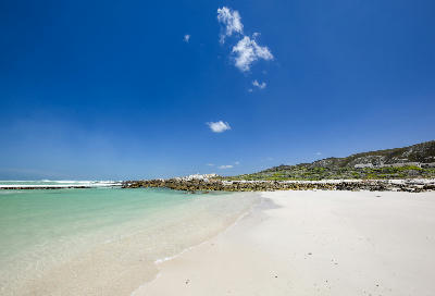 White sand beach and turquoise coastal water at Brandfontein near Cape Agulhas in the Western Cape, South Africa.