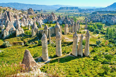 Tall fairy chimneys and volcanic rock formations in Love Valley, Cappadocia, Turkey.