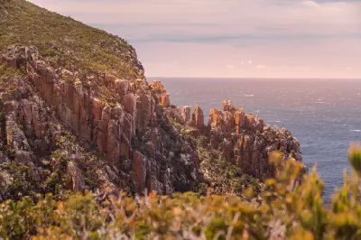 Dolerite cliffs glowing in warm evening light at Cape Hauy, Tasmania.