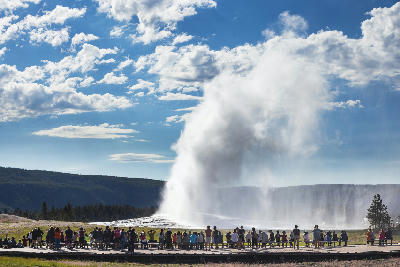 Old Faithful Geyser eruption with crowd on boardwalk Yellowstone National Park geothermal attraction Wyoming USA
