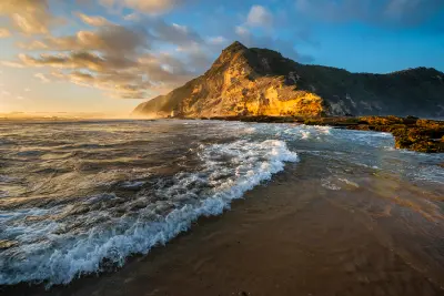 Golden-hour view of fossilised dune cliffs, waves and coastal rock formations at Gericke's Point near Sedgefield on the Garden Route.