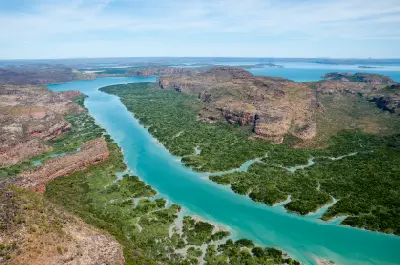 Turquoise waters of Porosus Creek wind through dense mangroves and rugged sandstone country in Prince Frederick Harbour.