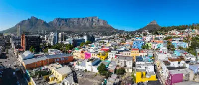 Aerial view of Bo-Kaap’s brightly painted houses with Table Mountain and Lion’s Head in the background, Cape Town, South Africa.
