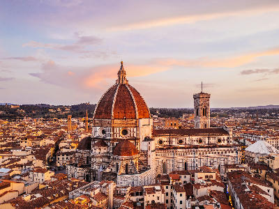 Aerial view of Florence Cathedral and Giotto’s Campanile at sunset, with a colourful sky over Florence, Tuscany, Italy.