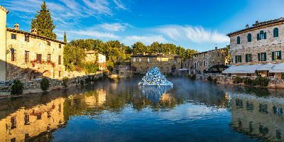 Thermal pool in the central square of Bagno Vignoni with art installation, Val d'Orcia, Tuscany, Italy.