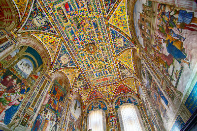 Colourful frescoed ceiling of the Piccolomini Library inside Siena Cathedral in Siena, Tuscany, Italy.