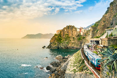 Train station in Manarola, with colourful houses perched on cliffs above the sea in Cinque Terre National Park, Liguria, Italy.