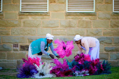 Women arranging colourful ostrich feather dusters in Oudtshoorn in South Africa’s Klein Karoo ostrich farming region.