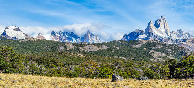 Mount Fitz Roy peaks rising above forest and steppe landscape seen from Pliegue Tumbado viewpoint near El Chaltén, Patagonia, Argentina.
