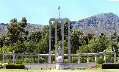 Huguenot Monument in Franschhoek with mountain backdrop in the Cape Winelands of South Africa.