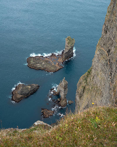 Risin og Kellingin sea stacks rising from the Atlantic Ocean below the cliffs of Eiðiskollur, Eysturoy, Faroe Islands.