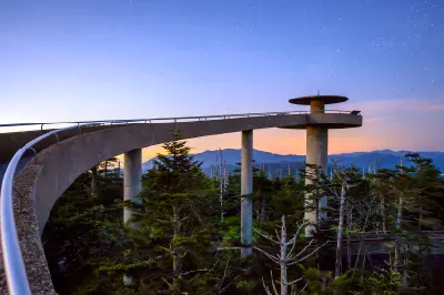 Curved observation tower walkway at Clingmans Dome under a starry twilight sky in the Great Smoky Mountains.