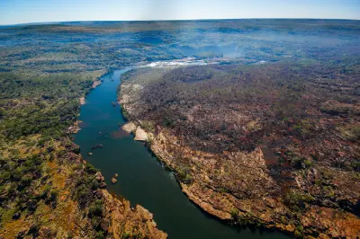 Aerial view of the Mitchell River winding through rugged sandstone and remote woodland as it flows toward Mitchell Falls.