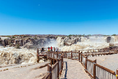 Visitors on the Augrabies Falls boardwalk overlooking the Orange River in flood.
