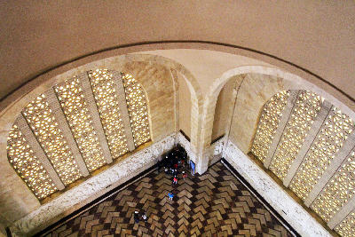View from the upper gallery of the Hall of Heroes showing geometric windows, marble floor and decorative frieze inside the Voortrekker Monument.