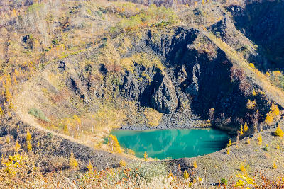 Turquoise crater lake inside Konpira crater on Mount Usu in Hokkaido, Japan.