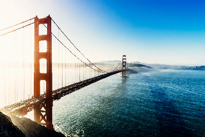 Golden Gate Bridge from Battery Spencer at sunrise with light fog drifting across the bay