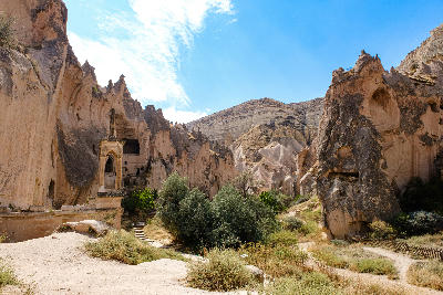 Historic rock-cut churches and cave dwellings carved into volcanic cliffs at Zelve Open Air Museum in Cappadocia, Turkey.