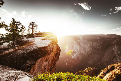Sunset light and lens flare at Taft Point overlooking Yosemite Valley in Yosemite National Park, California.