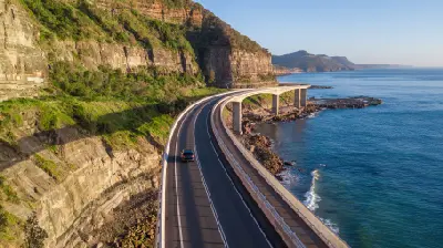 Sea Cliff Bridge curves between steep coastal cliffs and the Pacific Ocean along the scenic Illawarra coast of New South Wales.
