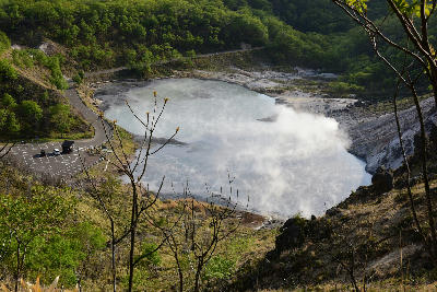 Elevated view of Oyunuma Pond with steaming sulphur water and surrounding volcanic slopes in Noboribetsu, Hokkaido, Japan.