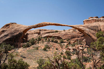 Landscape Arch long thin sandstone arch above rocky slope in Arches National Park Utah