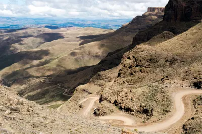 Steep gravel switchbacks descending Sani Pass through the Drakensberg mountains on the South Africa–Lesotho border.