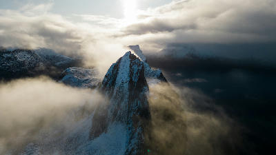 Drone view of Segla mountain peak surrounded by clouds in northern Norway