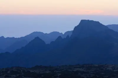 Layered volcanic ridges at sunset across the Shira Plateau on Mount Kilimanjaro, Tanzania, at an altitude of approximately 3,800–4,000 metres above sea level.