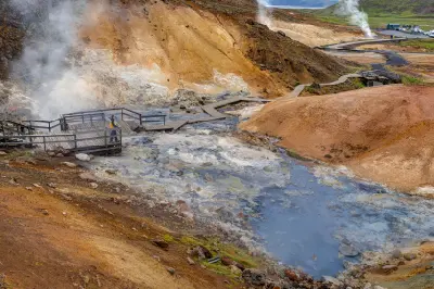 Wooden walkways crossing steaming hot springs and colourful sulphur hills at the Seltún geothermal area in Krýsuvík, Reykjanes Peninsula, Iceland.