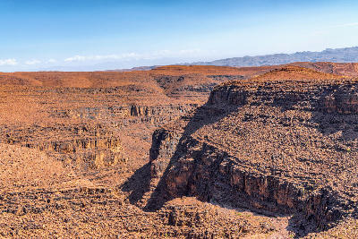 Layered canyon cliffs and desert plateau landscapes of Dades Gorge in Morocco