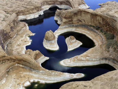 Aerial view Reflection Canyon Lake Powell curved sandstone formations low water levels Glen Canyon Arizona