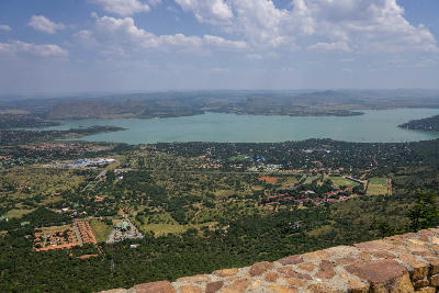 Panoramic view from the Hartbeespoort Aerial Cableway summit overlooking Hartbeespoort Dam and the Magaliesberg mountains in North West Province, South Africa.