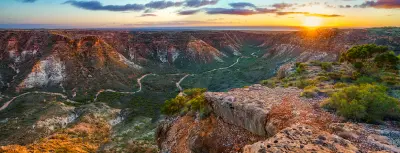 Sunrise illuminates the rugged walls and winding valley of Charles Knife Canyon.