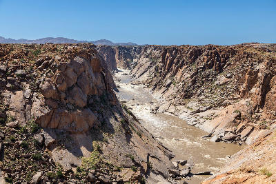 Orange River flowing through the steep granite cliffs of Oranjekom Gorge in Augrabies Falls National Park, Northern Cape, South Africa.