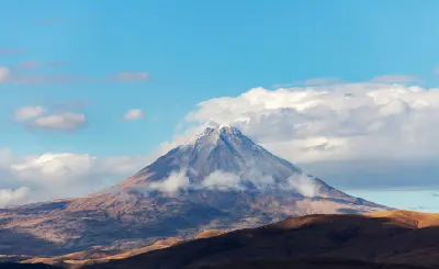Snow-covered summit of Mount Ararat rising above the highlands of Eastern Turkey beneath clouds.