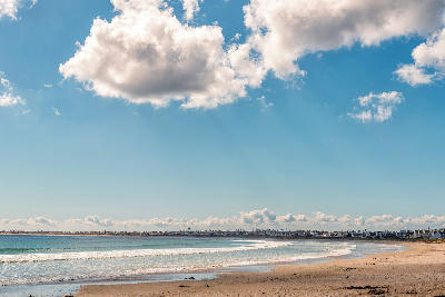 Curving sandy beach and coastal homes overlooking the calm waters of Britannia Bay on South Africa's West Coast.
