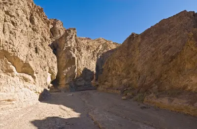 Golden Canyon trail Death Valley with narrow canyon walls leading toward Red Cathedral below Zabriskie Point