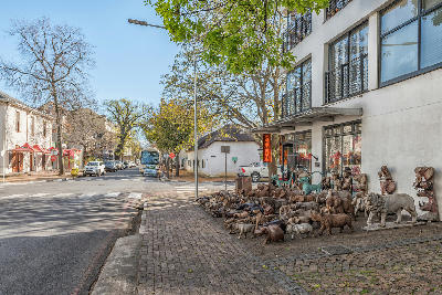 Ryneveld Street and Church Street intersection in Stellenbosch Town Centre with shops, trees, and historic streetscape in the Western Cape, South Africa.