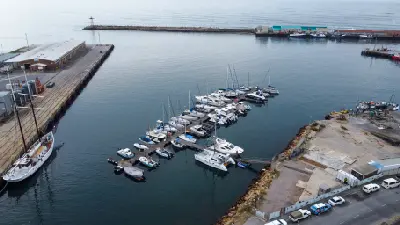 Yachts and small boats moored in the marina basin of Mossel Bay Harbour, Western Cape, South Africa.
