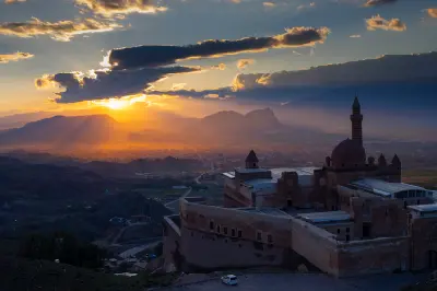 İshak Pasha Palace silhouetted against a dramatic sunset above Doğubayazıt in Eastern Turkey.