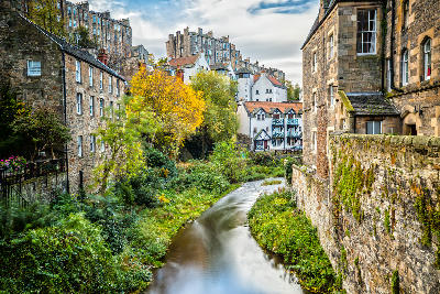 Dean Village and the Water of Leith surrounded by historic stone buildings in Edinburgh.