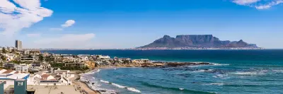 Bloubergstrand coastline with houses and Table Mountain across Table Bay, Cape Town, South Africa.