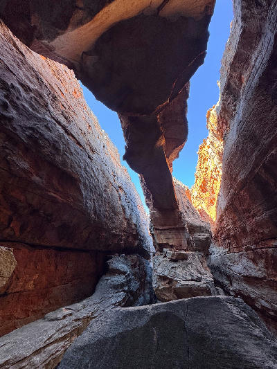 Massive sandstone walls and a natural rock bridge inside Wolfberg Cracks in the Cederberg Wilderness Area, Western Cape, South Africa.