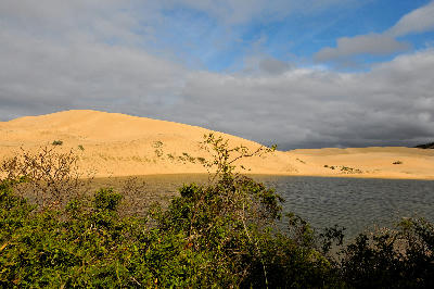 Large coastal sand dunes beside the Sundays River estuary under dramatic clouds in the Eastern Cape, South Africa.