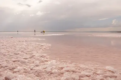 Pink shallow water and thick salt crystals along the shoreline of Lake Tuz, Turkey.