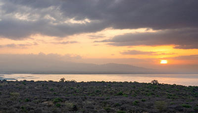 Sunrise over Lake Manyara with the Rift Valley escarpment reflected across the lake in Tanzania.