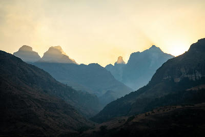 Sunrise behind Cathedral Peak and the surrounding Drakensberg mountains in KwaZulu-Natal, South Africa.