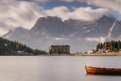 Famous lakeside building on Lago di Misurina, with Dolomite mountain peaks rising in the background near Misurina, Italy.