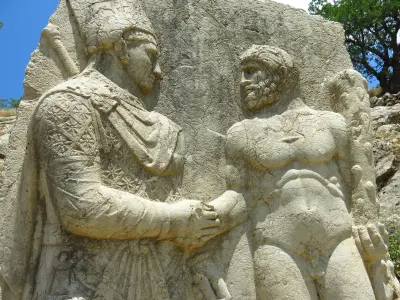 Ancient stone relief of King Antiochus I shaking hands with Heracles at Arsameia, Turkey.